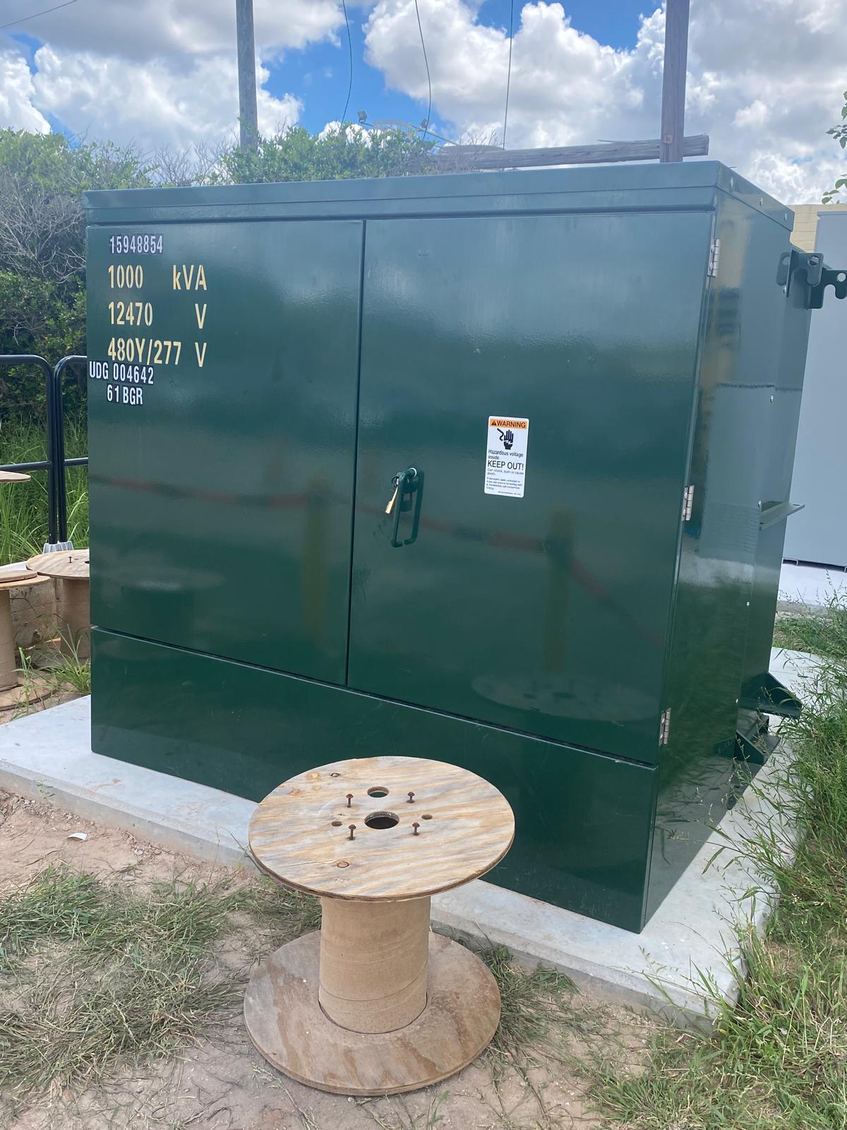 Pad-mounted electrical transformer on a concrete base